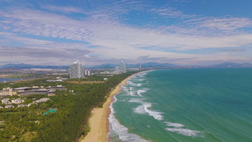  Aerial footage of Haitang Bay in Sanya, Hainan, with Luxury Hotels and Resorts Situated along the beach.