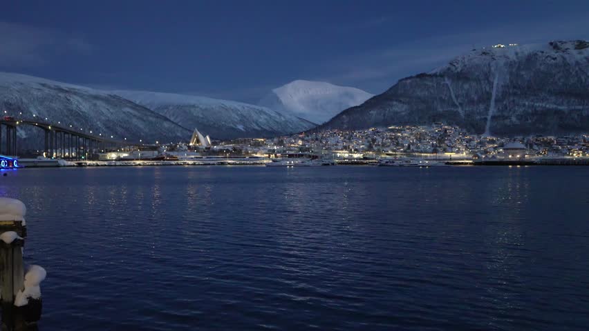Panoramic view of Tromso city at dusk with Arctic Cathedral and Tromso Bridge, Norway.