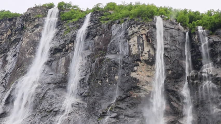 Iconic seven sisters waterfall cascading down steep cliffs in Geirangerfjord Norway