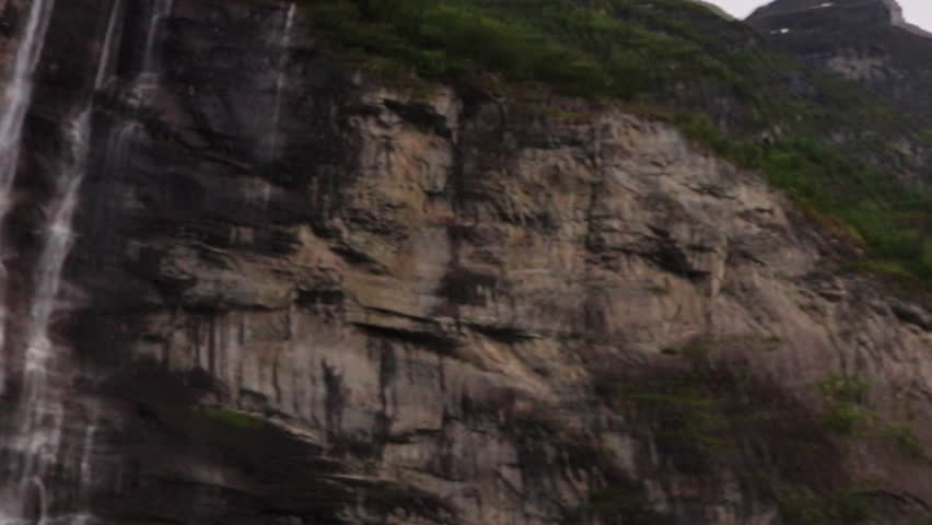 Iconic seven sisters waterfall cascading down steep cliffs in Geirangerfjord Norway