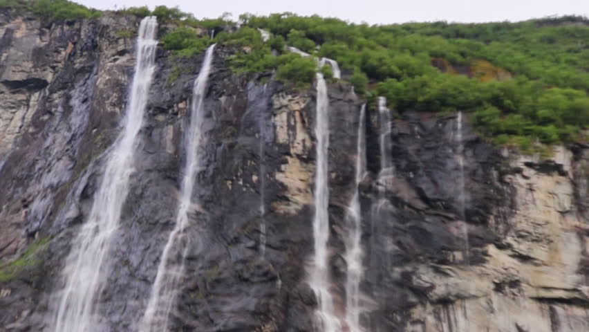 Iconic seven sisters waterfall cascading down steep cliffs in Geirangerfjord Norway