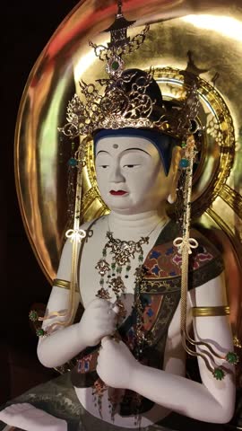 Elegant White Buddha Statue with Golden Ornaments Inside Temple