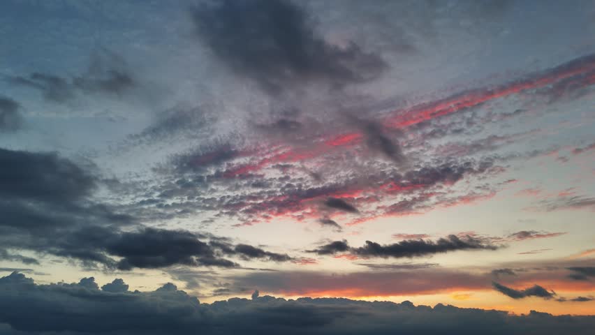 Dramatic colorful clouds moving during sunset