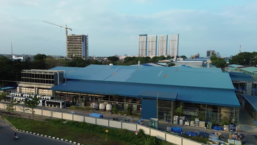 Aerial view of a growing metropolitan industrial area, contrasting with modern skyscrapers.