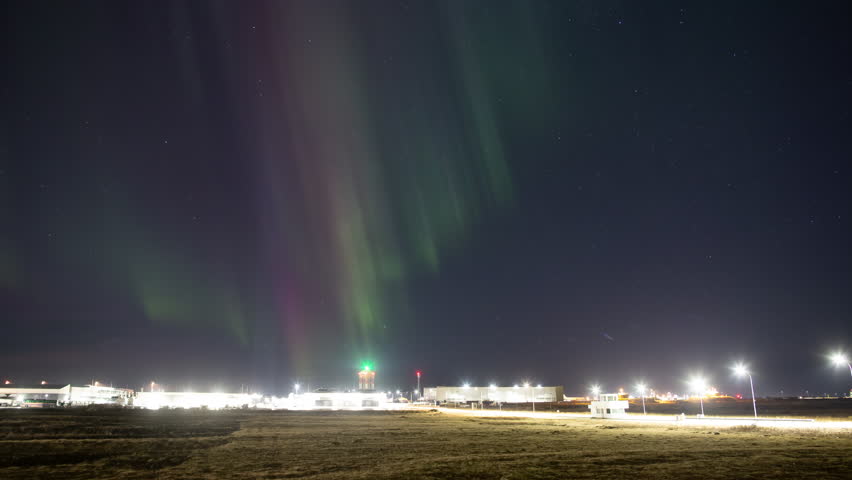 Colorful strong aurora borealis over old Keflavik Iceland air force base