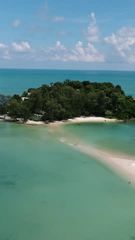 An isolated island with white sands and calm waters on shores. Cape Fahn. Ko Samui, Thailand.