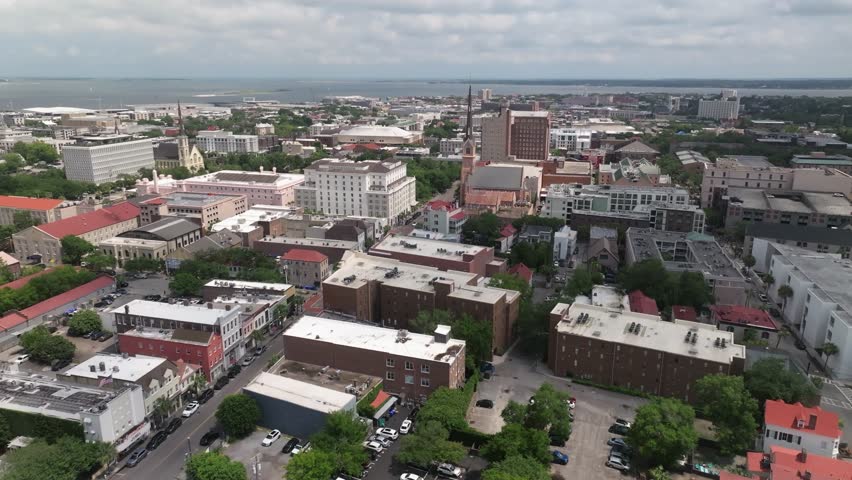 Aerial view of downtown skyline church steeple landscapes of coastal Charleston, South Carolina showcasing lowcountry metropolitan neighborhood scenery - 4K Drone