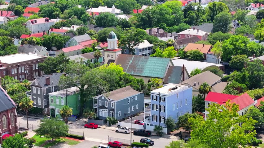 Aerial view of stunning houses in neighborhood landscapes of coastal Charleston, South Carolina downtown skyline showcasing lowcountry metropolitan scenery - 4K Drone