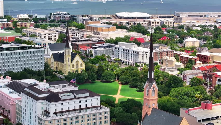 Skyline view of Marion Square and downtown church steeple landscapes of coastal Charleston, South Carolina showcasing lowcountry metropolitan neighborhood scenery - 4K Drone