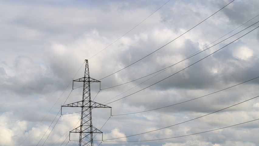 The image shows Power Lines Against a Cloudy Sky, highlighting the dramatic atmosphere