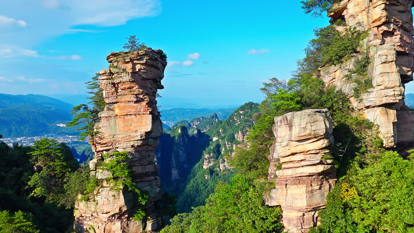 Aerial shot of magnificent sandstone pillars and lush green forest in Zhangjiajie National Forest Park, Hunan Province, China. 