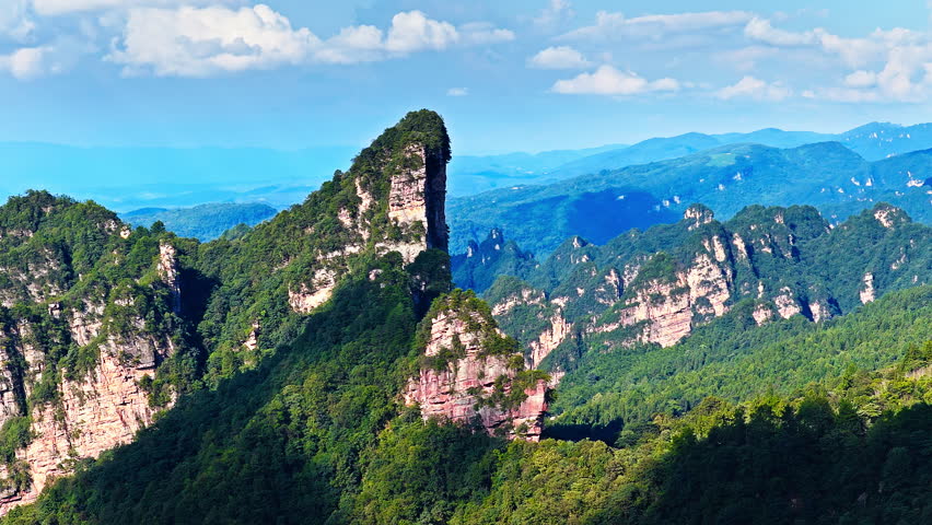 Aerial shot of magnificent sandstone pillars and lush green forest in Zhangjiajie National Forest Park, Hunan Province, China. 