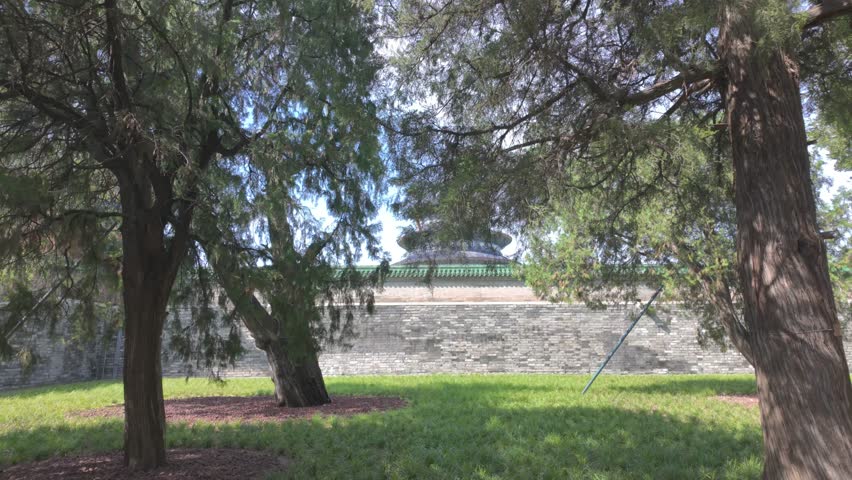 Partial view of the Temple of Heaven behind the trees from a park with in Beijing, China