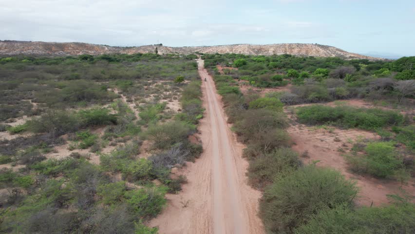Aerial view of motorcycle riding on dirt road in Araya Peninsula