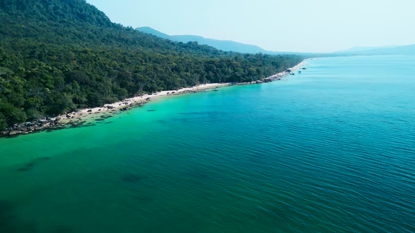 Tropical aerial view of Starfish Beach Phu Quoc Island Vietnam showing emerald sea, rocky coast and untouched green jungle. Ideal travel concept for luxury resort promo, tourism marketing