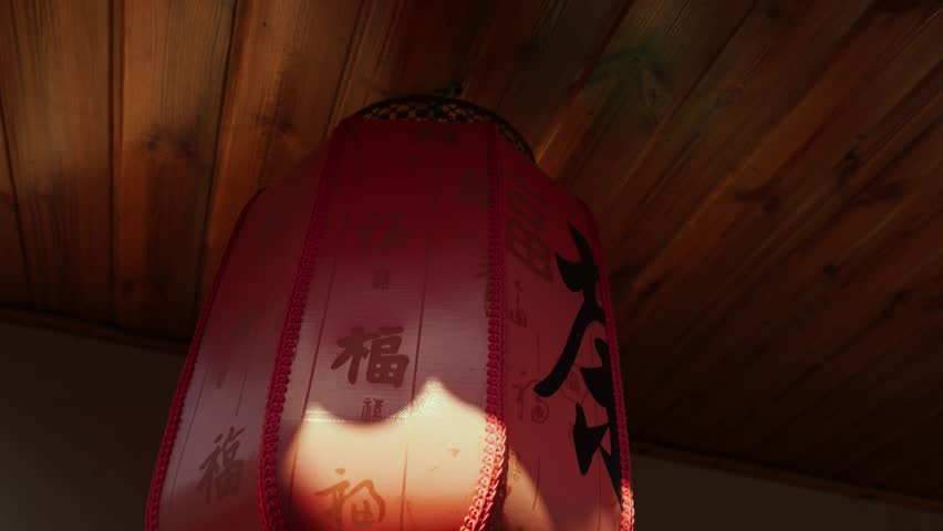Red Chinese Lantern Hanging from Wooden Ceiling Eaves