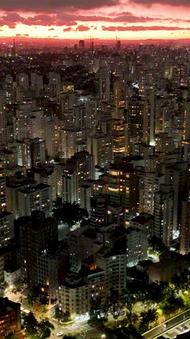 Sunset at Sao Paulo Brazil. Cityscape of sunset sky at city Sao Paulo Brazil. Scenic landscape of colorful sky and illuminated towers offices buildings and skyscrapers. Urban life scenery.