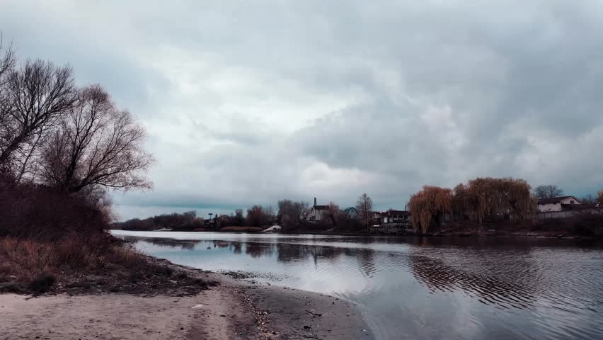 Beautiful autumn landscape with a lake and blue water. Landscape in cinematic colors. Sunset on the lake. 4K 60fps.
