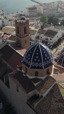 Scenic vertical drone view above Altea, highlighting the Church of Our Lady of Consuelo and the Mediterranean town below.