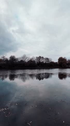 Beautiful autumn landscape with a lake and blue water. Landscape in cinematic colors. Sunset on the lake. 4K 60fps.
