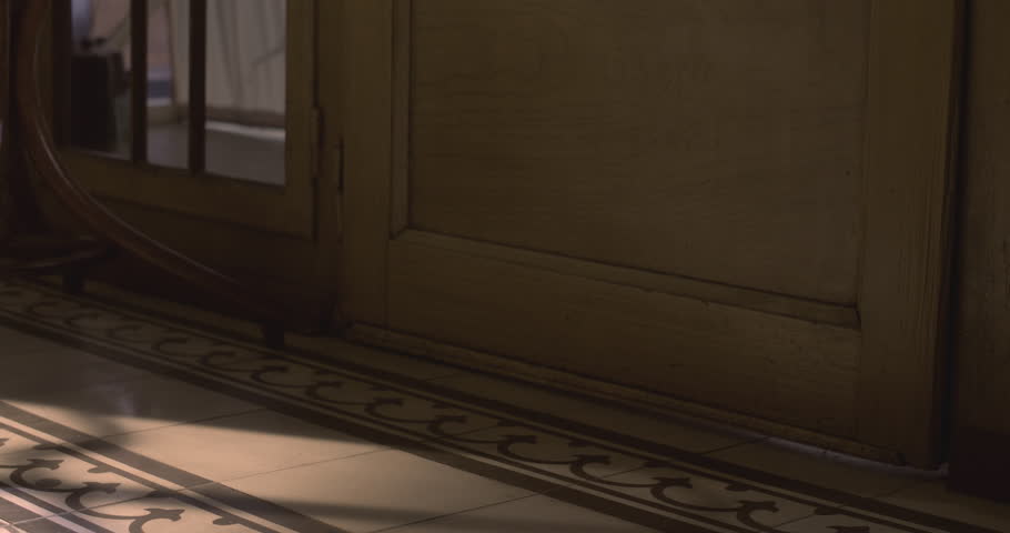 Girl enters a retro 1950s-style shop, close-up on vintage shoes and footsteps.