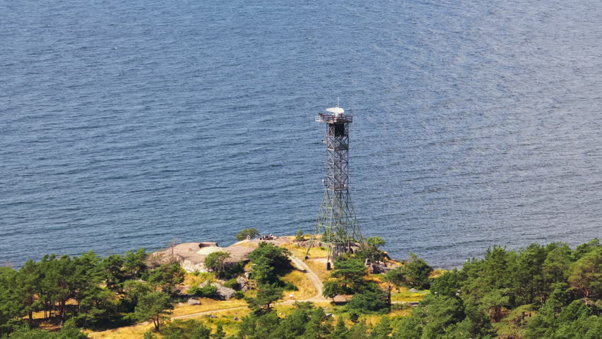 Telephoto drone shot around a radar and canon in the archipelago of Finland, summer