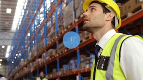 Animation of network of digital icons on caucasian male supervisor using digital tablet at warehouse. Global networking and logistics business technology concept - Powered by Shutterstock - Get 15% off with code: PIKWIZARD15