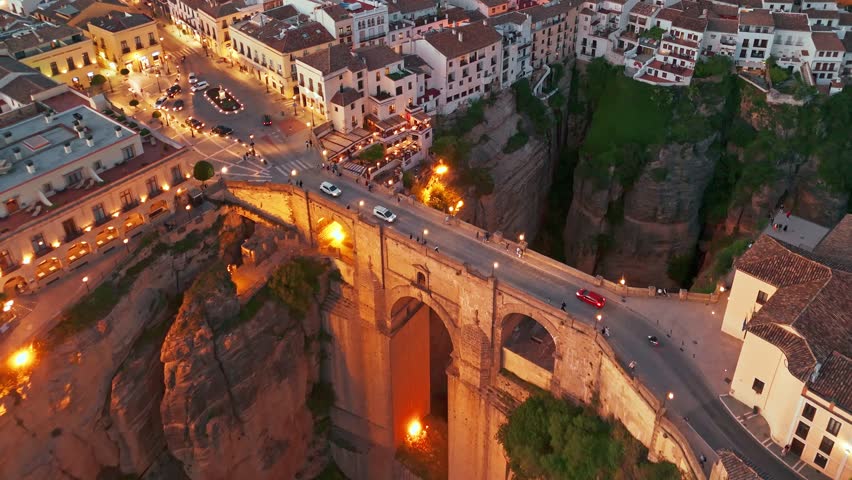 Ronda, Spain. Aerial view of the New Bridge over Guadalevin River in Ronda medieval town at twilight, Andalusia, Spain. Famous UNESCO heritage city and Puente Nuevo bridge at sunset