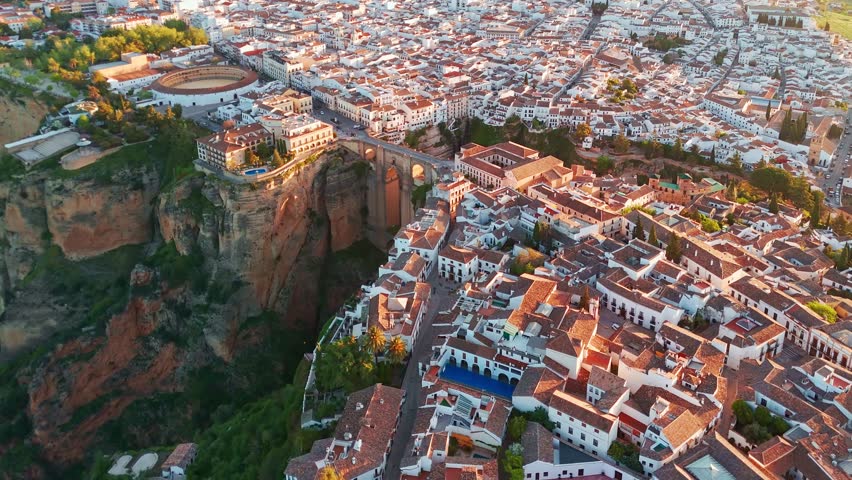 Ronda, Spain. Aerial view of the New Bridge over Guadalevin River in Ronda medieval town at sunrise, Andalusia, Spain. Famous UNESCO heritage city and Puente Nuevo bridge at sunset