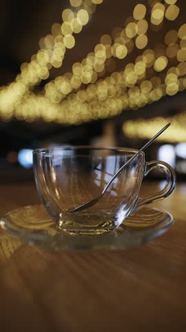 Pour raspberry tea into a cup in restaurant, slow motion vertical video