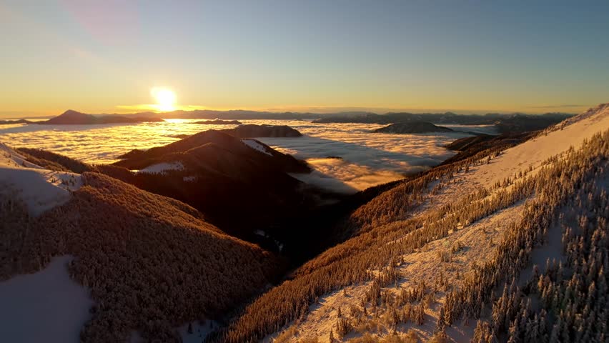 Aerial Video of Sun Rising over Winter Mountain Inversion, winter forest and mountains