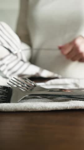Girl Wiping Dry The Clean Washed Forks And Cutlery In A Light Kitchen, Vertical Video