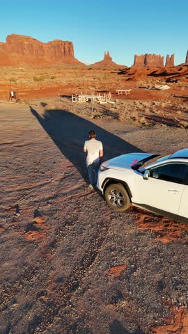 Person and White SUV Monument Valley Aerial, Vertical