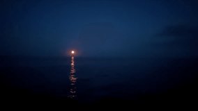 Full moon rising over calm sea at night with moonlight reflection on water surface. Dark blue sky and peaceful atmosphere. Meditation and relaxation content - Powered by Shutterstock - Get 15% off with code: PIKWIZARD15