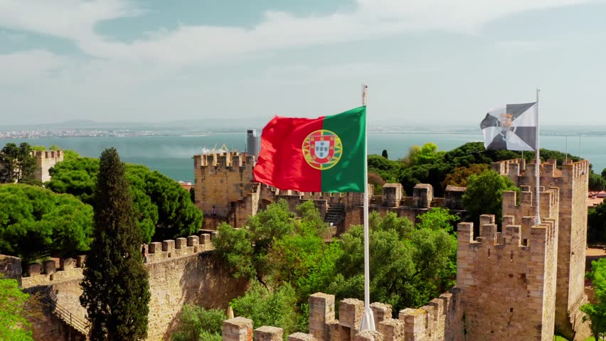 Aerial view of Portugal featuring the national flag overlay and cityscape panoramas, including historic architecture, red-tiled roofs, rivers, and coastal areas, captured on January 26 2026
