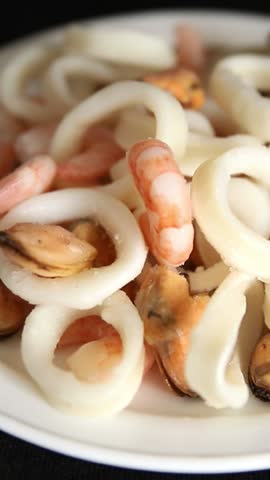 Raw seafood mix shrimp, scallops, mussels, prawns tasty snack fresh delicious gourmet food background on the table rustic food top view copy space pescetarian diet