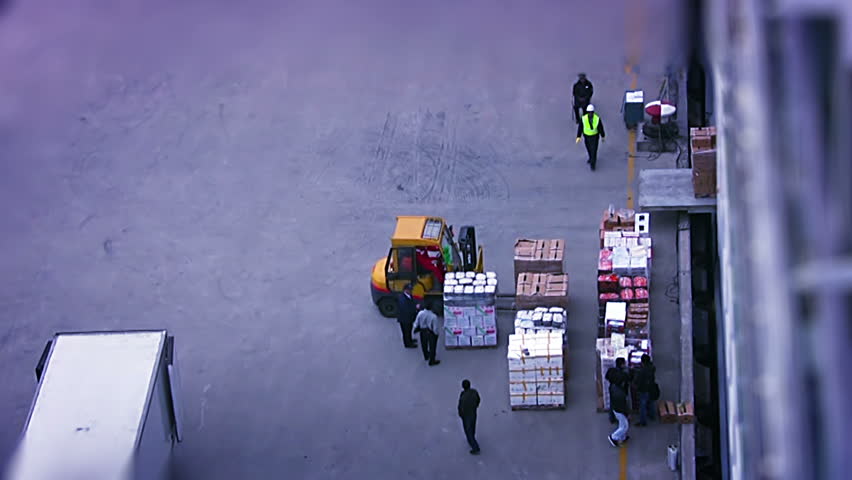 Early in the morning. Forklift loads food into a large cruise ship. Top view.