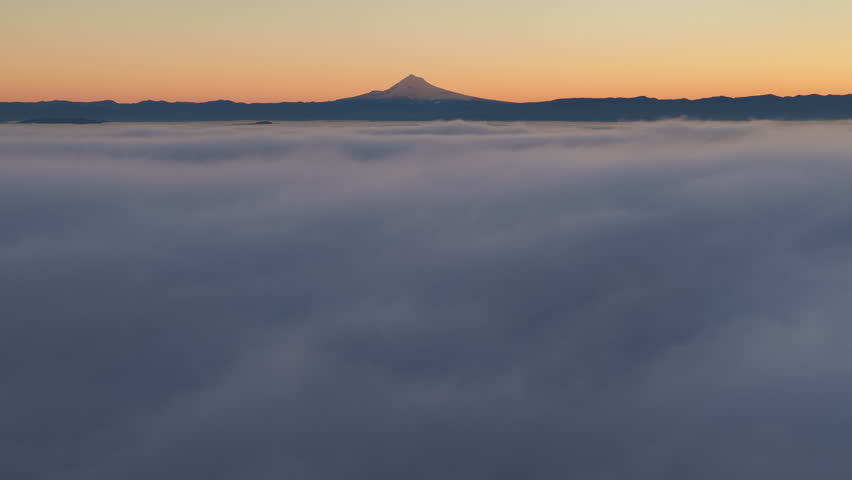 A blanket of fog drifts through the Willamette Valley with Mt. Hood, OR, in the distance. The Pacific Northwest is known for its scenic forests, waterfalls, and rivers, as well as its wet weather.