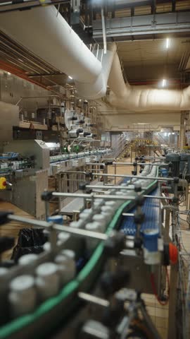 Automated bottling production line in industrial factory hall