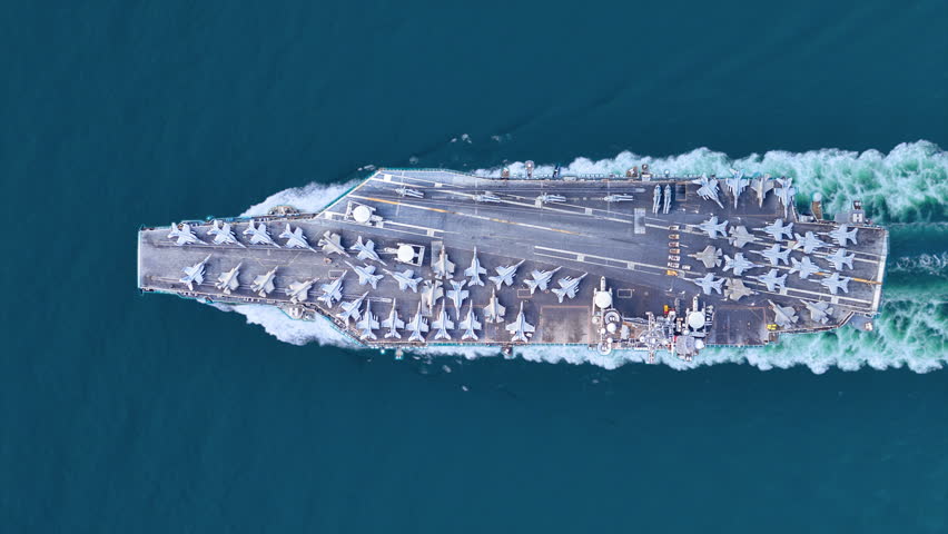 Nuclear ship warship Military navy ship carrier full loading fighter jet aircraft and Helicopters sailing in the ocean. Military warship deck loaded with fighter jets Naval defense power army force 