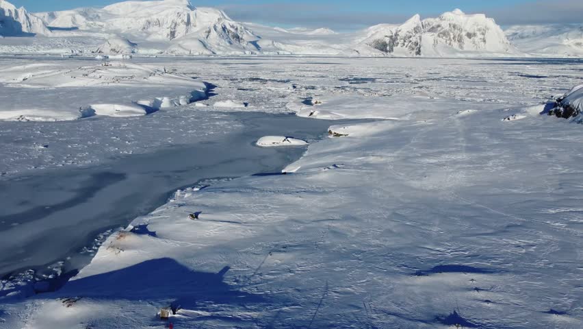 Icy Antarctic Landscape with Frozen Water, Aerial 4K Winter View