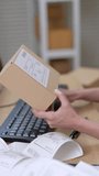 Asian woman entrepreneur holding parcel box close up while checking shipping label details, managing online shopping order accuracy, supporting e-commerce packaging process inside home warehouse - Powered by Shutterstock - Get 15% off with code: PIKWIZARD15