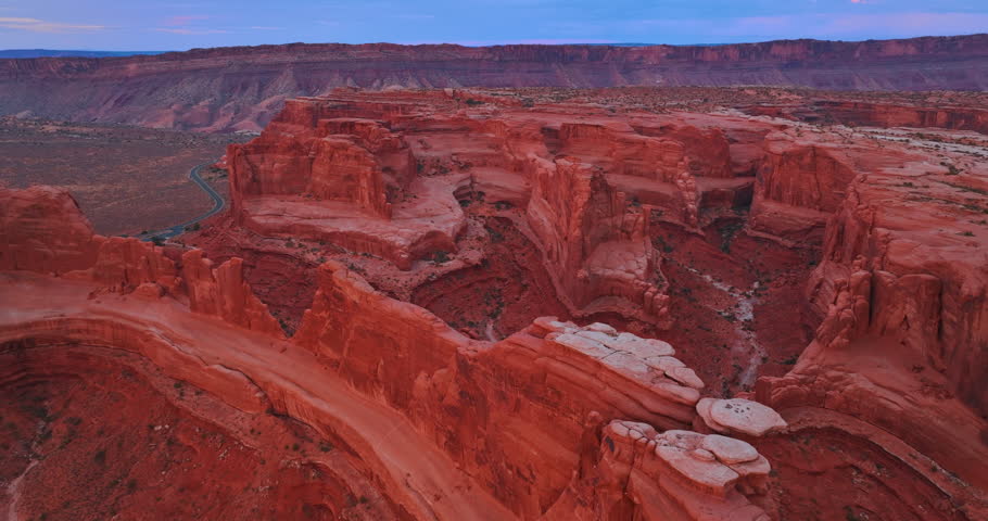 Differently shaped red canyons from drone. Aerial perspective on the stunning Arches National Park, Utah, USA.