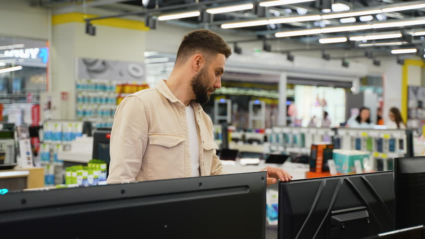 Customer examining televisions in electronics store
