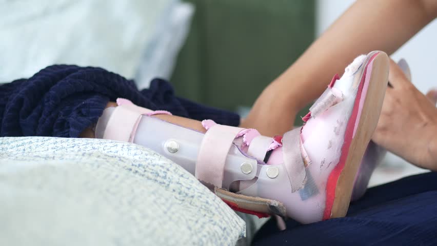 Child receiving treatment with orthopedic brace at home 