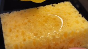 Close-up video of yellow dishwashing liquid being poured from a yellow bottle onto a yellow dish sponge. Detailed shot of the liquid flow and texture, with bright colors and clean composition. Household cleaning concept, kitchen chores, dishwashing routine, soap and sponge, hygiene and home care. Macro view of the product in action with shallow depth of field. - Powered by Shutterstock - Get 15% off with code: PIKWIZARD15