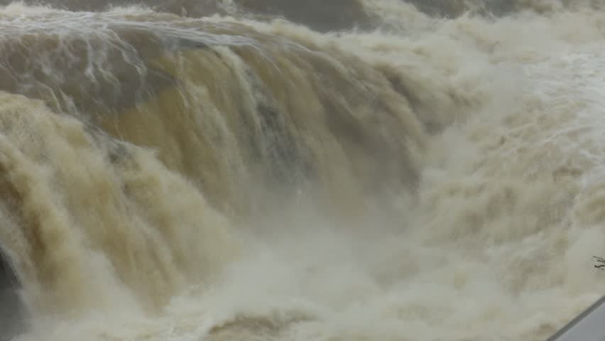 After days of relentless rain, the Cadagua River surges through Alonsotegi with an intensity rarely seen. Its waters, normally calm as they wind between the town’s bridges and wooded banks, now rush forward in a powerful torrent, churning in shades of brown and white. The swollen current crashes against rocks and river walls, carrying branches and debris as a reminder of the storm’s force. In the misty air, the roar of the river dominates the landscape, capturing a raw and dramatic moment in this Basque valley as nature briefly reclaims its strength