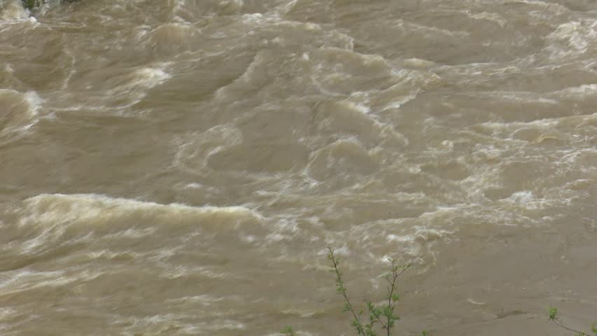 After days of relentless rain, the Cadagua River surges through Alonsotegi with an intensity rarely seen. Its waters, normally calm as they wind between the town’s bridges and wooded banks, now rush forward in a powerful torrent, churning in shades of brown and white. The swollen current crashes against rocks and river walls, carrying branches and debris as a reminder of the storm’s force. In the misty air, the roar of the river dominates the landscape, capturing a raw and dramatic moment in this Basque valley as nature briefly reclaims its strength
