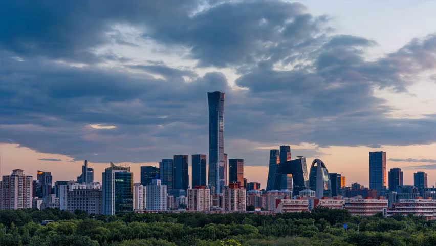 This stunning video captures the vibrant Beijing Central Business District skyline during the golden hour of dusk. The footage showcases the sleek, futuristic architecture of China Zun—Beijing