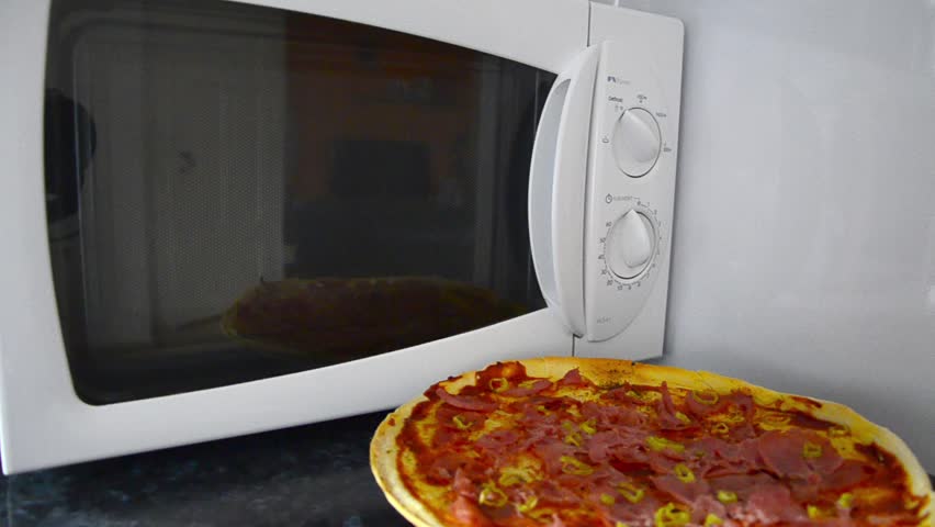 Pizza, Pepperoni pizza hited in microwave oven slow rotation.